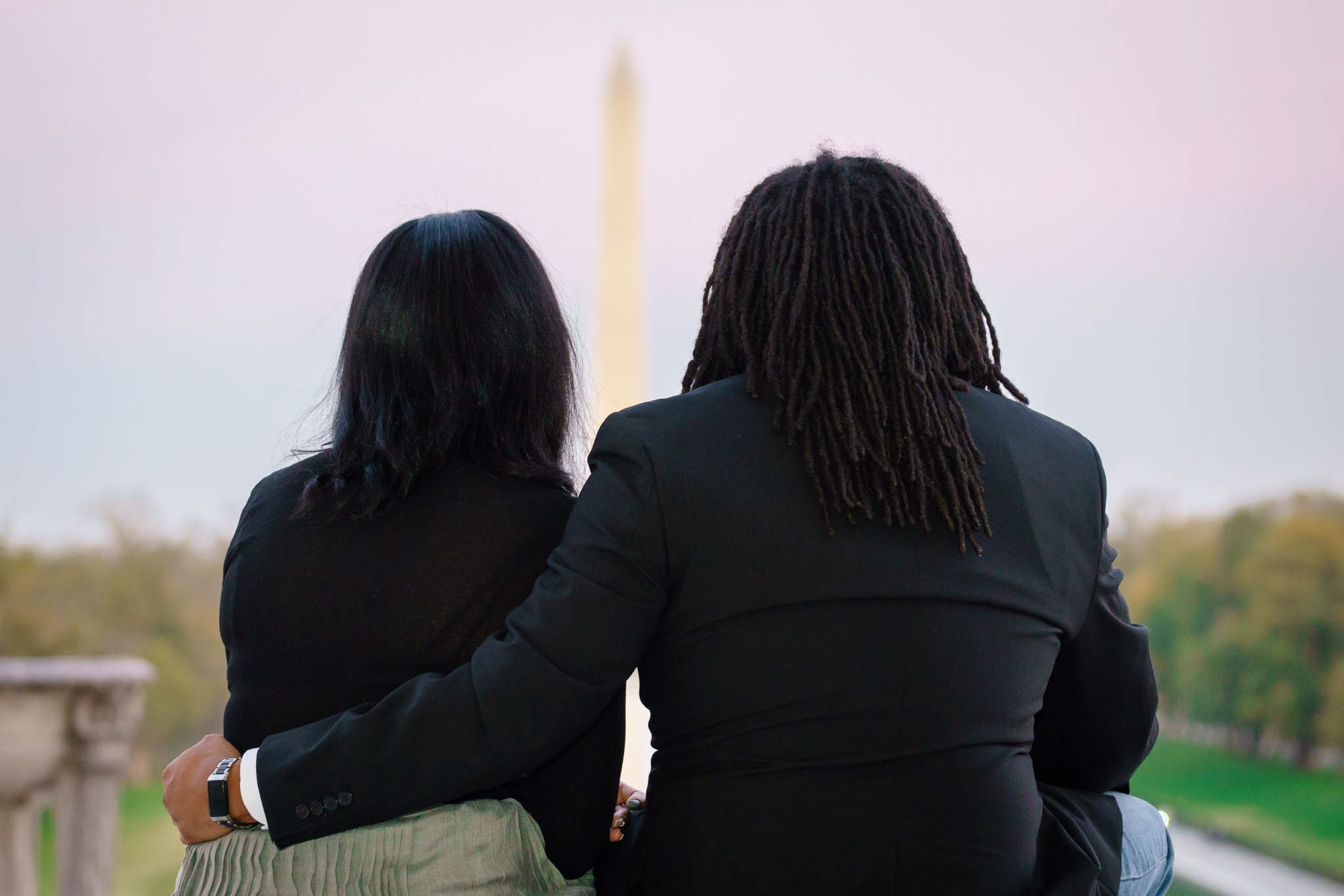 Black couple staring at washington monument at lincoln memorial engagement session derek lamar studios